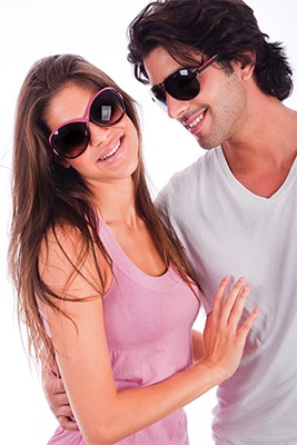 Jeune couple souriant et portant des verres fumés